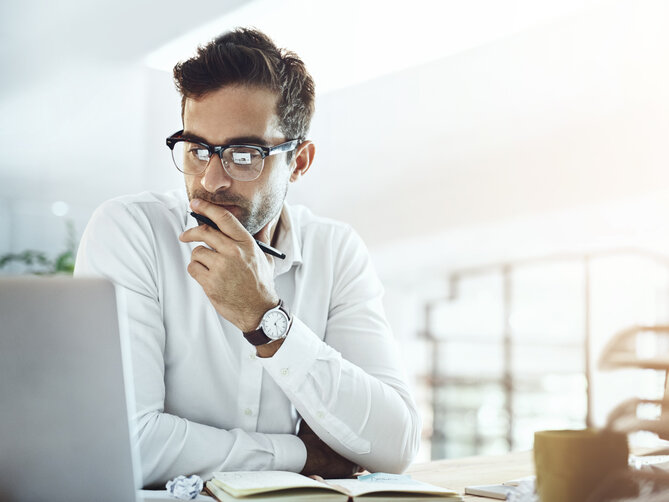 Computer, thinking and business man in office, working on project or email. Laptop, professional and male person problem solving, looking for solution or planning, reading or focus on decision making.